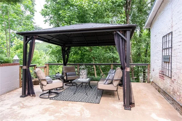 a view of backyard with deck and outdoor seating