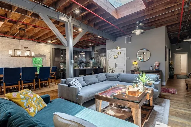 a living room with furniture and a clock