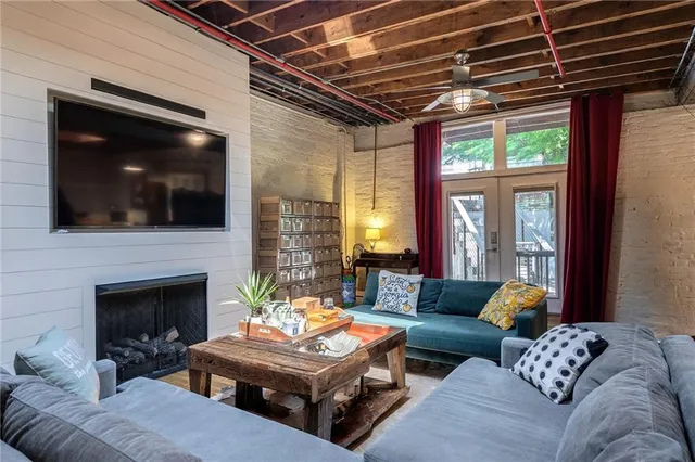 a living room with furniture a fireplace and a flat screen tv