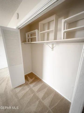 a view of an empty room and a window