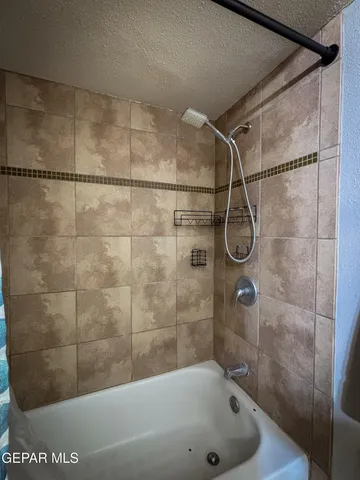 a bathroom with a toilet and a shower curtain