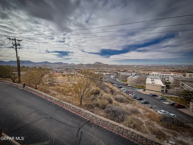 a living room with furniture a flat screen tv and kitchen view