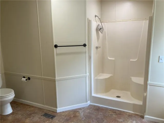 a bathroom with a shower and a toilet