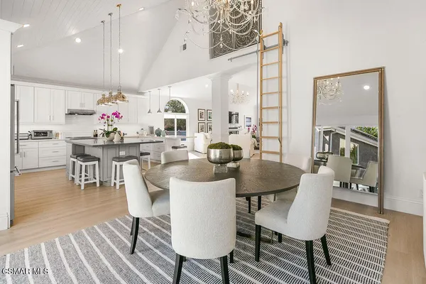 a view of a dining room with furniture wooden floor and chandelier