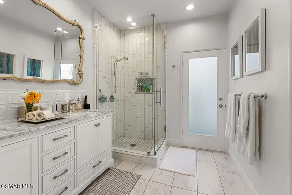 a bathroom with a granite countertop sink a toilet and bathtub