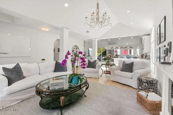 a living room with furniture and a chandelier