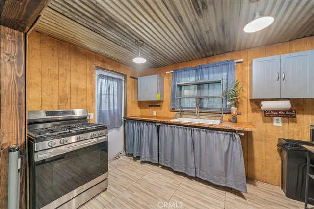 a kitchen with wooden cabinets and a stove top oven