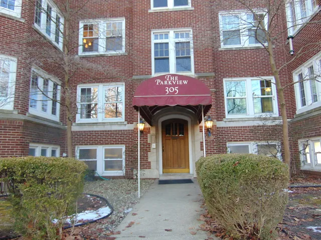 a front view of a building with a yard