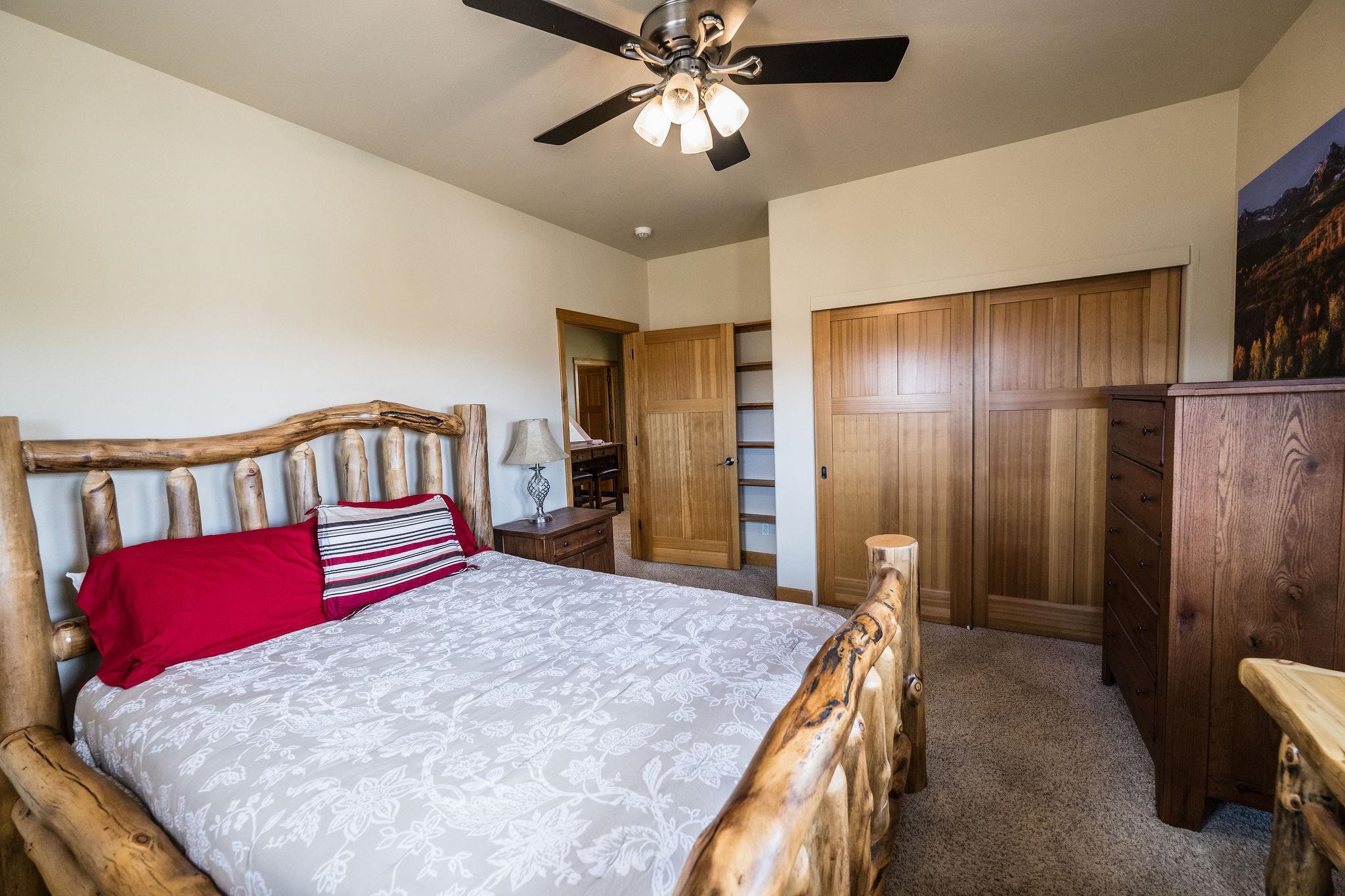 2069 Spur Cross Road Grand Junction, CO 81507 - Photo 25 of 40 a bedroom with a bed and a chandelier