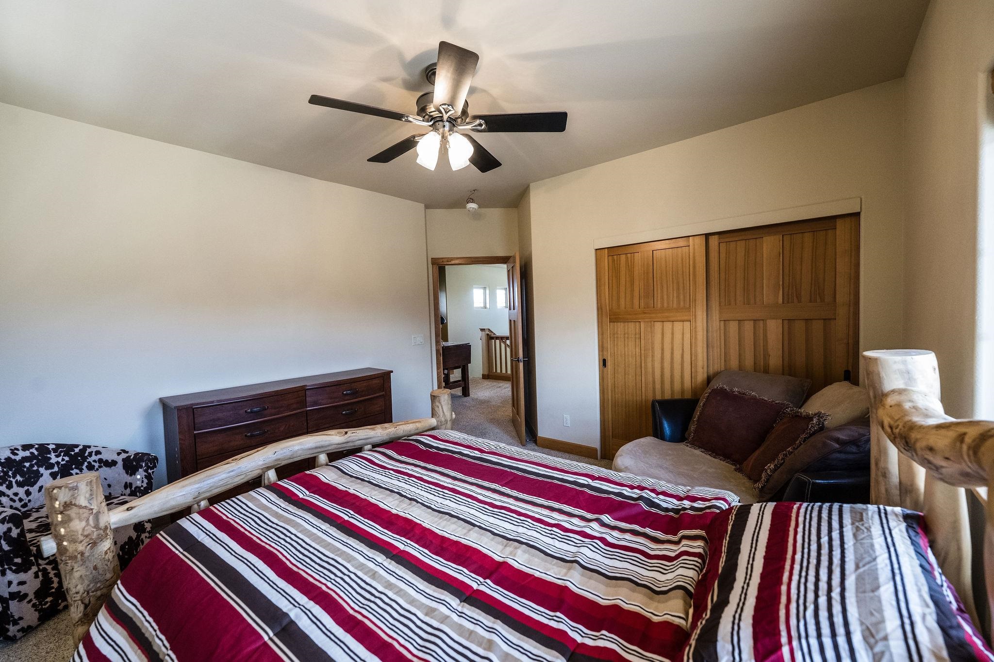 2069 Spur Cross Road Grand Junction, CO 81507 - Photo 27 of 40 a bedroom with bed and wooden floor