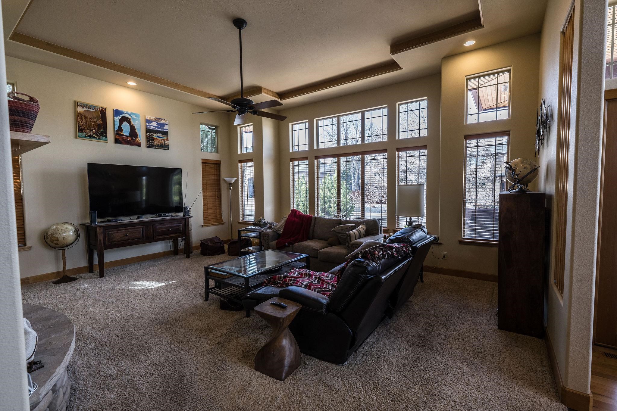 2069 Spur Cross Road Grand Junction, CO 81507 - Photo 4 of 40 a living room with furniture a flat screen tv and a large window