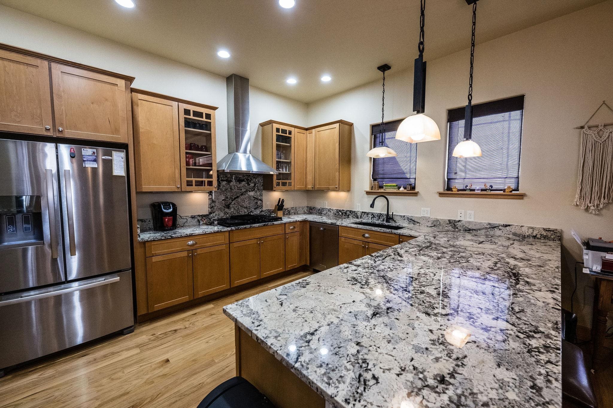 2069 Spur Cross Road Grand Junction, CO 81507 - Photo 8 of 40 a kitchen with stainless steel appliances granite countertop a sink a stove and a refrigerator