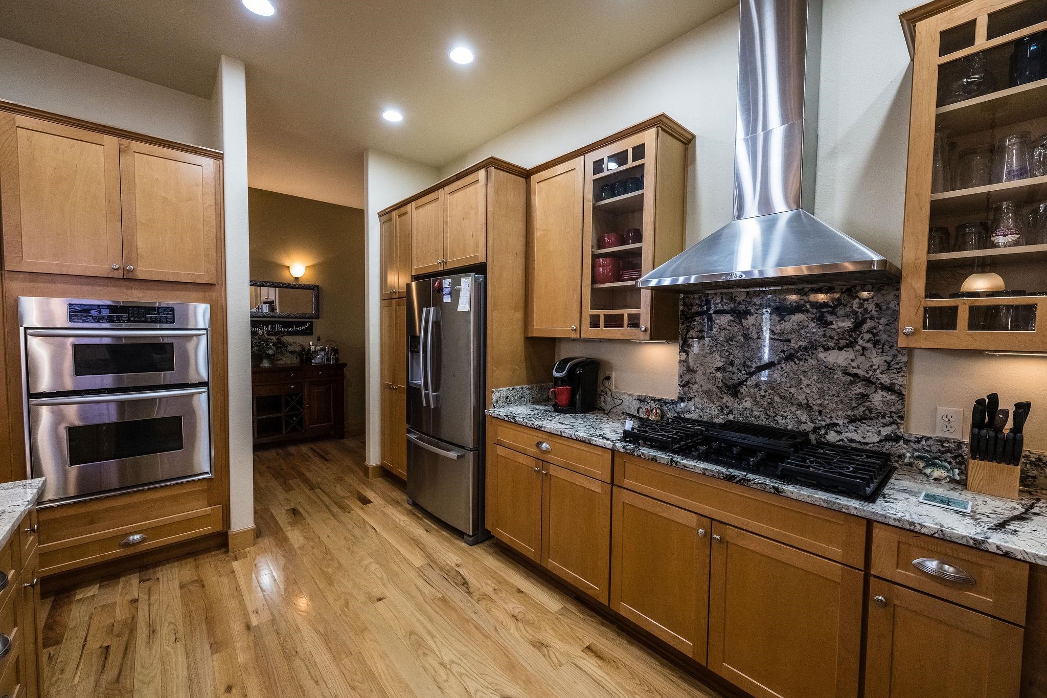 2069 Spur Cross Road Grand Junction, CO 81507 - Photo 9 of 40 a kitchen with stainless steel appliances granite countertop a stove a sink and a refrigerator