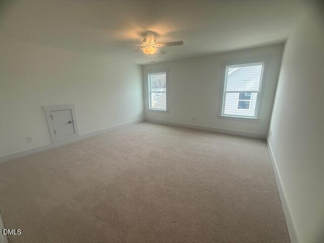 35 Slippery Elm Road Youngsville, NC 27596 - Photo 21 of 37 en empty room with windows and chandelier fan