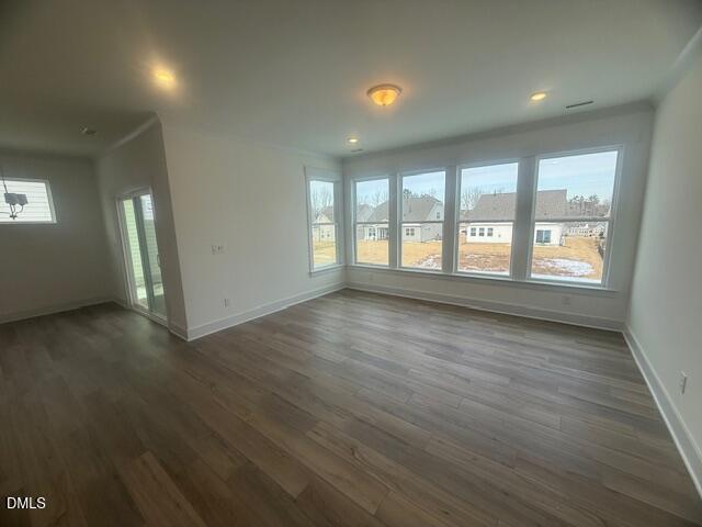 35 Slippery Elm Road Youngsville, NC 27596 - Photo 7 of 37 an empty room with wooden floor and windows
