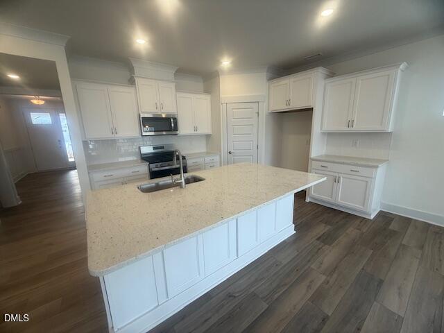 35 Slippery Elm Road Youngsville, NC 27596 - Photo 9 of 37 a kitchen with kitchen island a stove a sink and a refrigerator