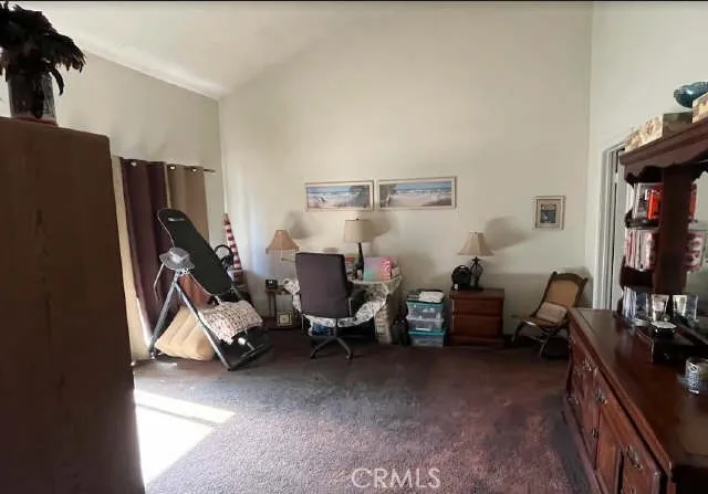 a living room with furniture a flat screen tv and a window