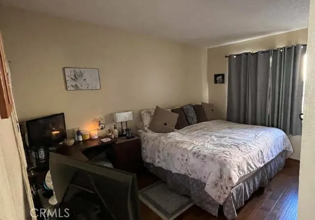 a bedroom with a bed a desk and chair