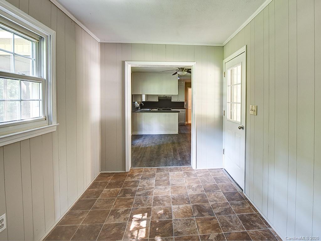 858 State Rd S-29-376 Lancaster, SC 29720 - Photo 11 of 28 a view of a hallway with wooden floor and a bathroom