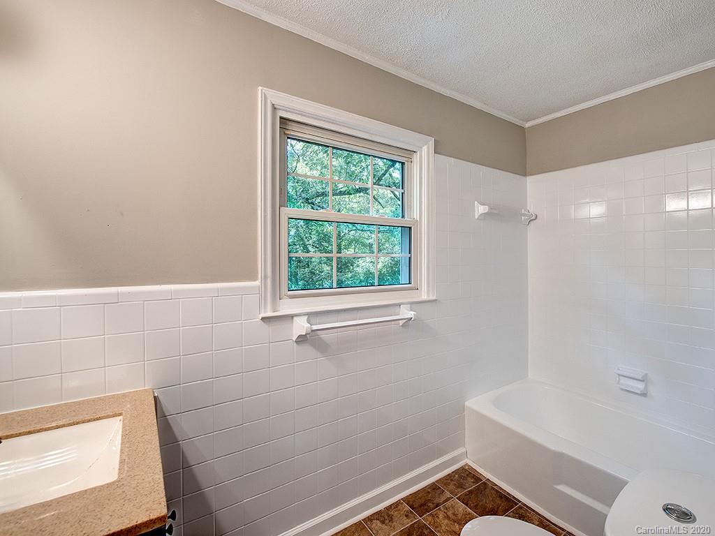 858 State Rd S-29-376 Lancaster, SC 29720 - Photo 13 of 28 a bathroom with a bathtub and window