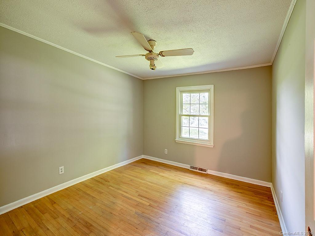 858 State Rd S-29-376 Lancaster, SC 29720 - Photo 16 of 28 wooden floor in an empty room with a window