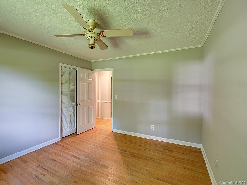 858 State Rd S-29-376 Lancaster, SC 29720 - Photo 17 of 28 a view of a room with wooden floor a ceiling fan and staircase