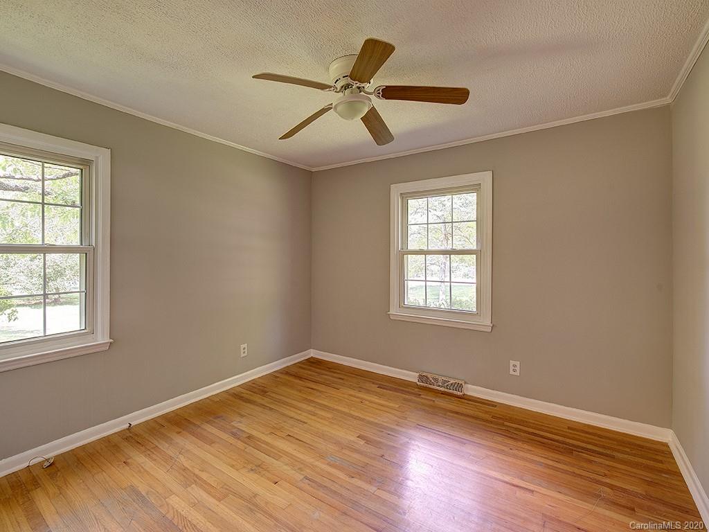 858 State Rd S-29-376 Lancaster, SC 29720 - Photo 18 of 28 a view of empty room with wooden floor and fan