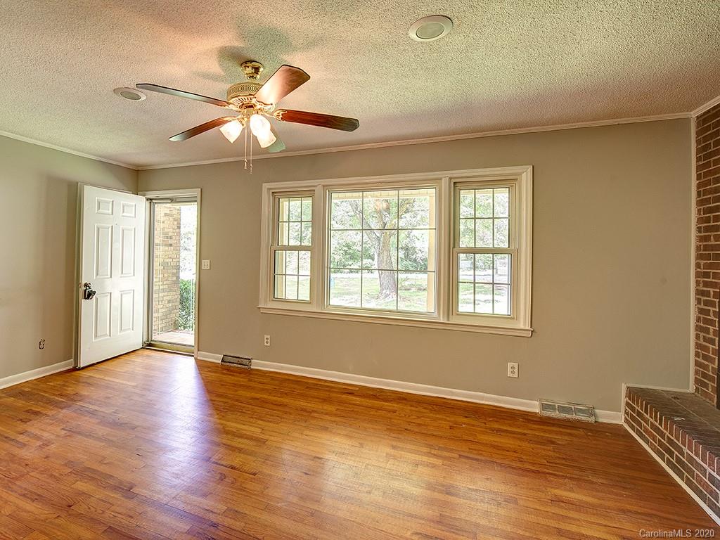 858 State Rd S-29-376 Lancaster, SC 29720 - Photo 3 of 28 a view of an empty room with wooden floor and a window