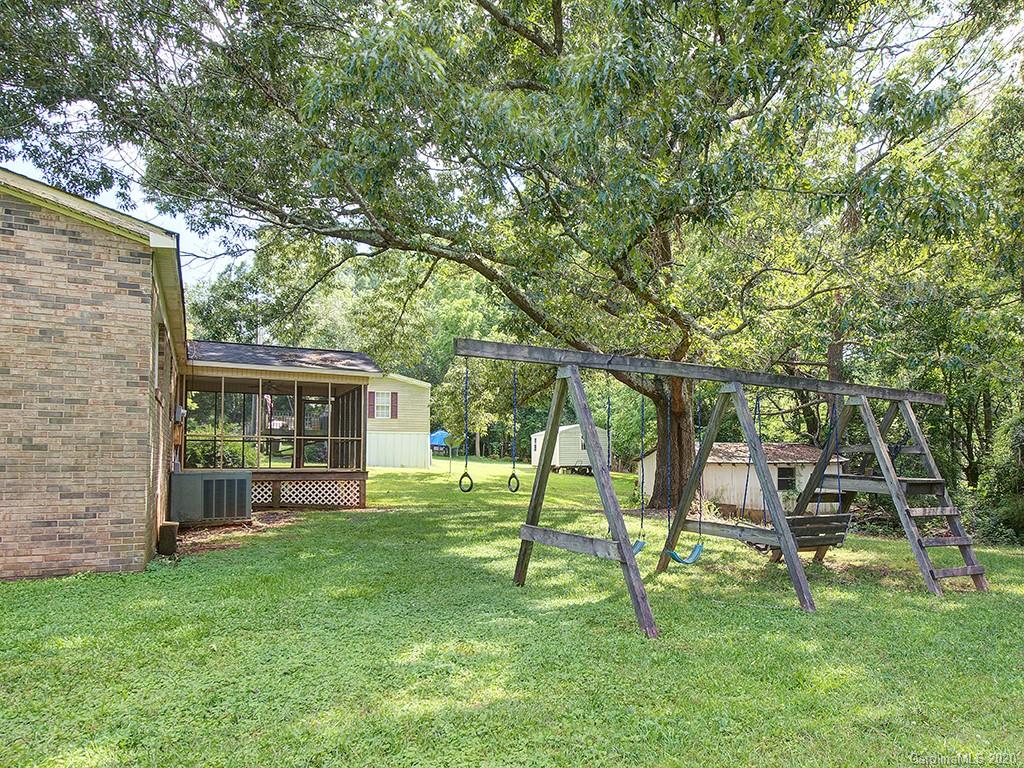 858 State Rd S-29-376 Lancaster, SC 29720 - Photo 26 of 28 a view of a backyard with table and chairs and a large tree