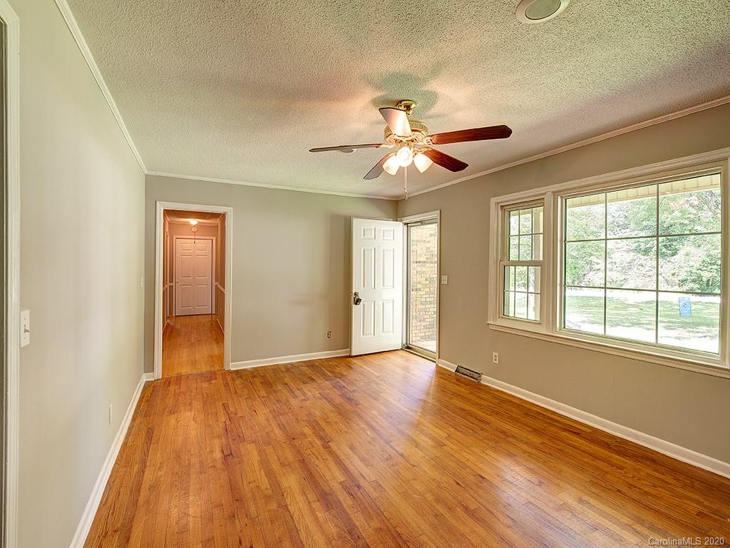 858 State Rd S-29-376 Lancaster, SC 29720 - Photo 4 of 28 a view of an empty room with a window and wooden floor