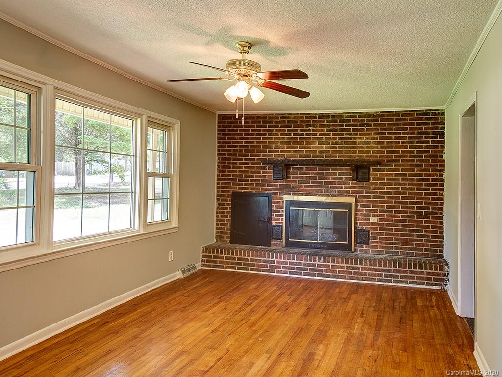 858 State Rd S-29-376 Lancaster, SC 29720 - Photo 5 of 28 a view of an empty room with wooden floor and a window