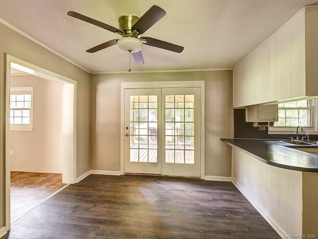 858 State Rd S-29-376 Lancaster, SC 29720 - Photo 9 of 28 a view of a kitchen with a sink and wooden floor