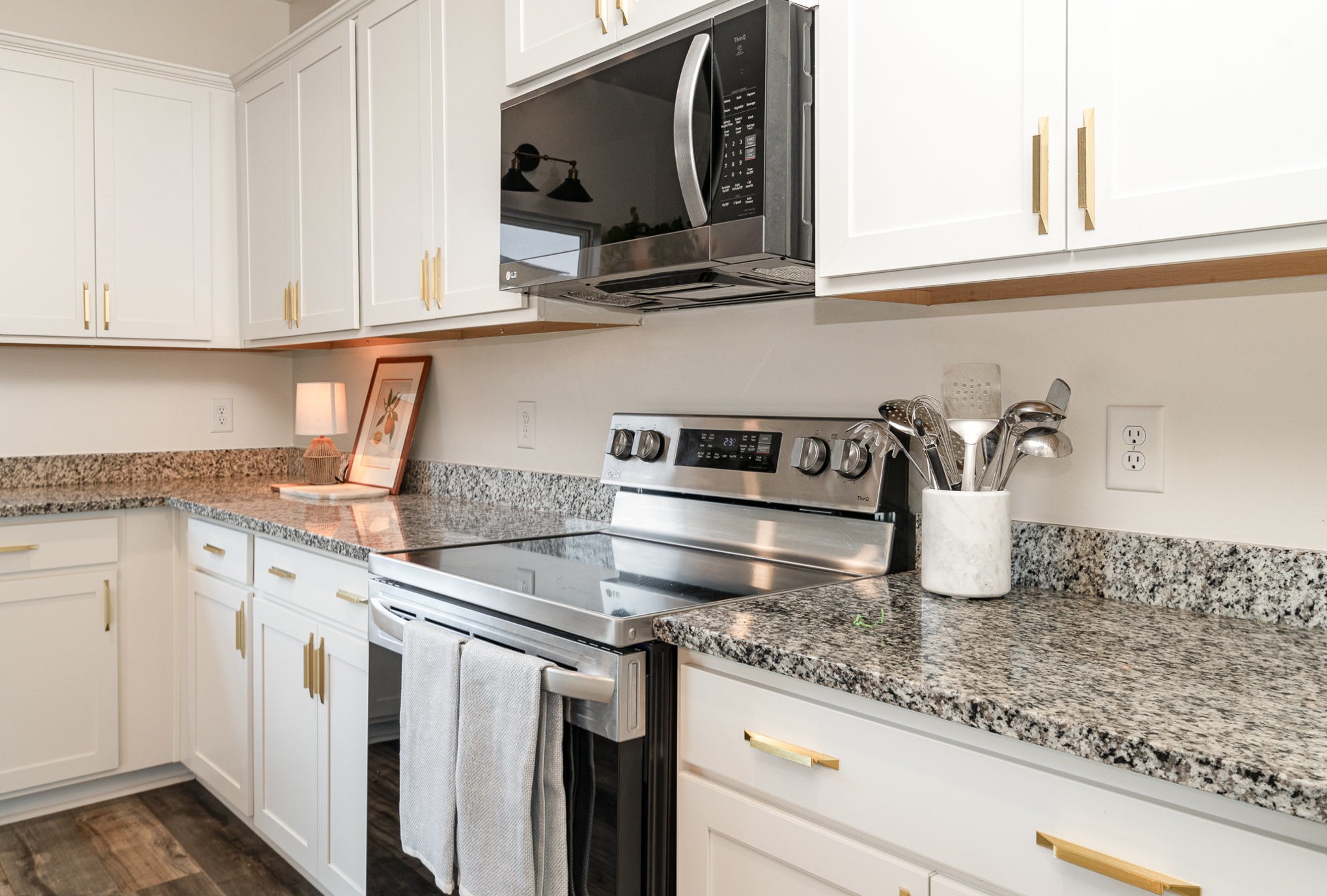 956 Carraway Lane Spring Hill, TN 37174 - Photo 11 of 27 a kitchen with granite countertop white cabinets and a sink
