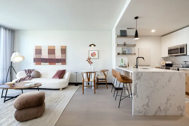 a living room with lots of furniture and a large window