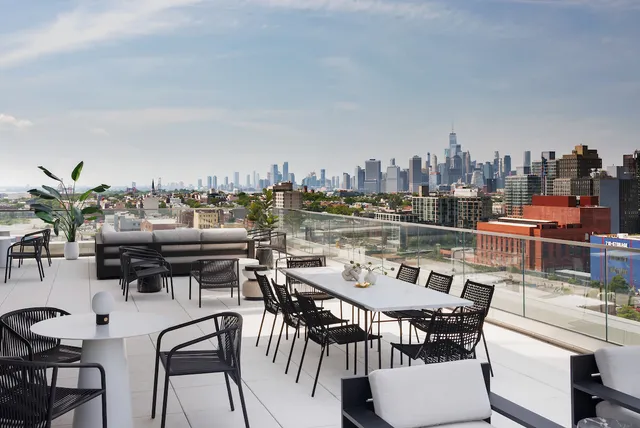 a outdoor kitchen with a table and chairs