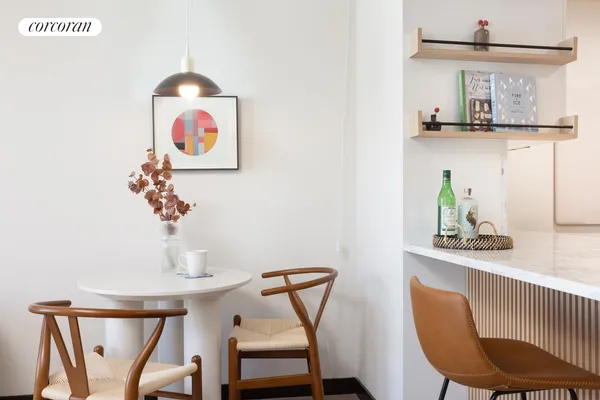 a living room with furniture and kitchen view