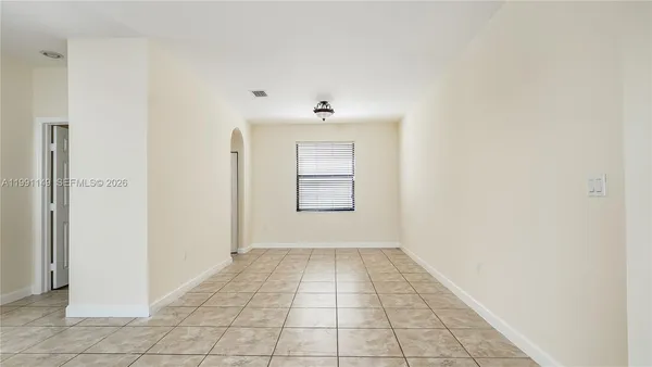 a view of a kitchen with an empty space and a window