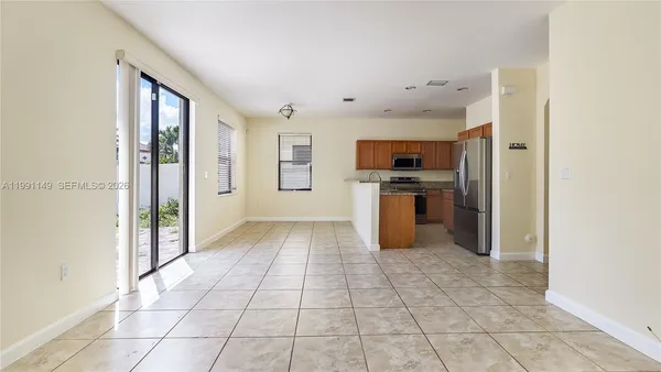 a kitchen with stainless steel appliances granite countertop a refrigerator a stove top oven a sink and dishwasher