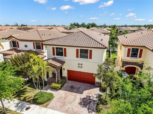 a aerial view of a house with a yard and plants