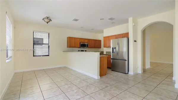 a kitchen with stainless steel appliances granite countertop a stove and a microwave
