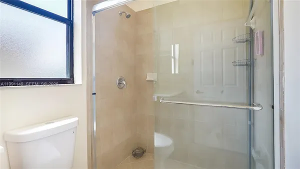 a bath room with a toilet sink and shower