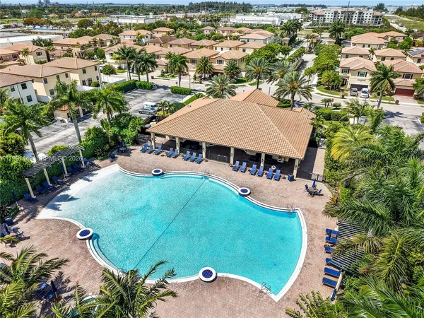 an aerial view of a house with yard swimming pool and outdoor seating