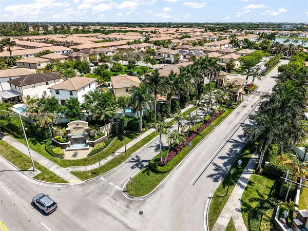an aerial view of a residential houses with yard
