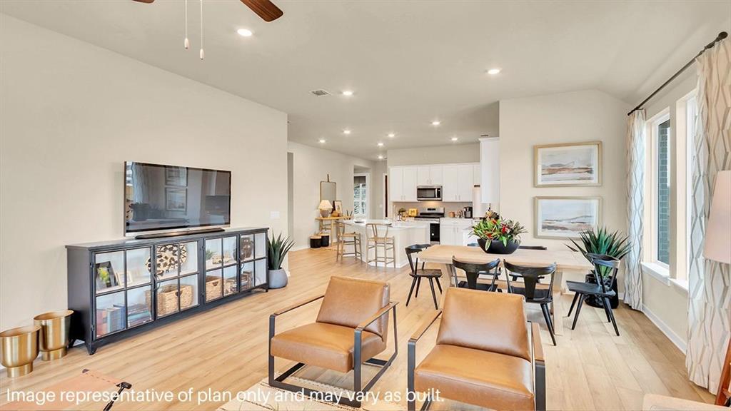 1620 Buckskin Road Oak Point, TX 75068 - Photo 12 of 26 a living room with furniture a flat screen tv and a floor to ceiling window