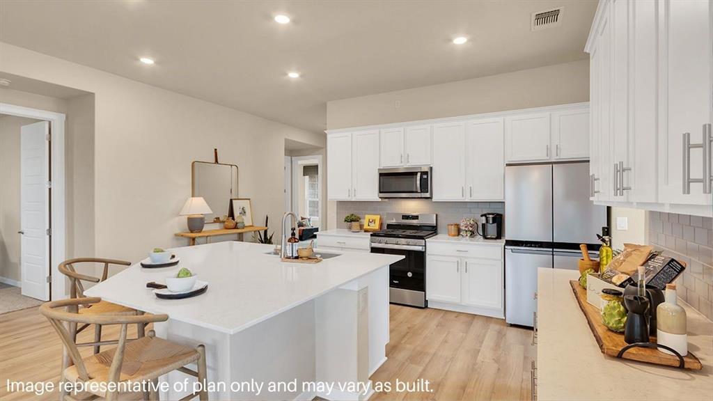 1620 Buckskin Road Oak Point, TX 75068 - Photo 7 of 26 a kitchen with stainless steel appliances granite countertop a sink a stove a refrigerator cabinets and living room view