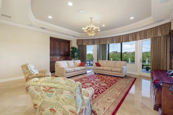 a living room with furniture and a chandelier