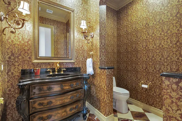 a bathroom with a granite countertop sink a toilet and a mirror
