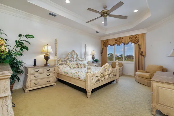 a bedroom with a bed a lamp and window