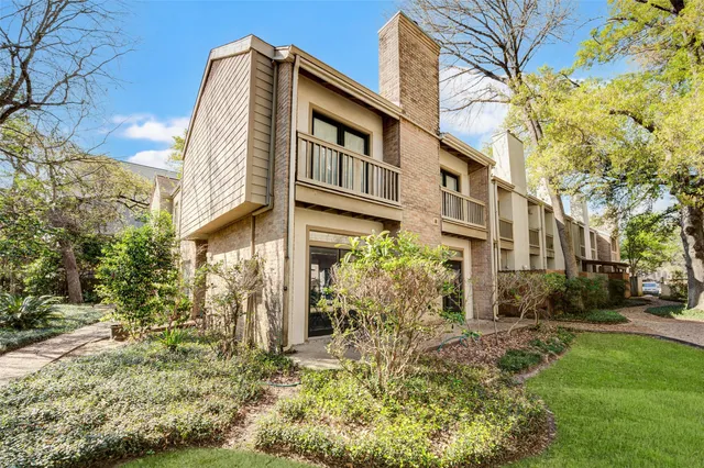 a front view of a building with a garden