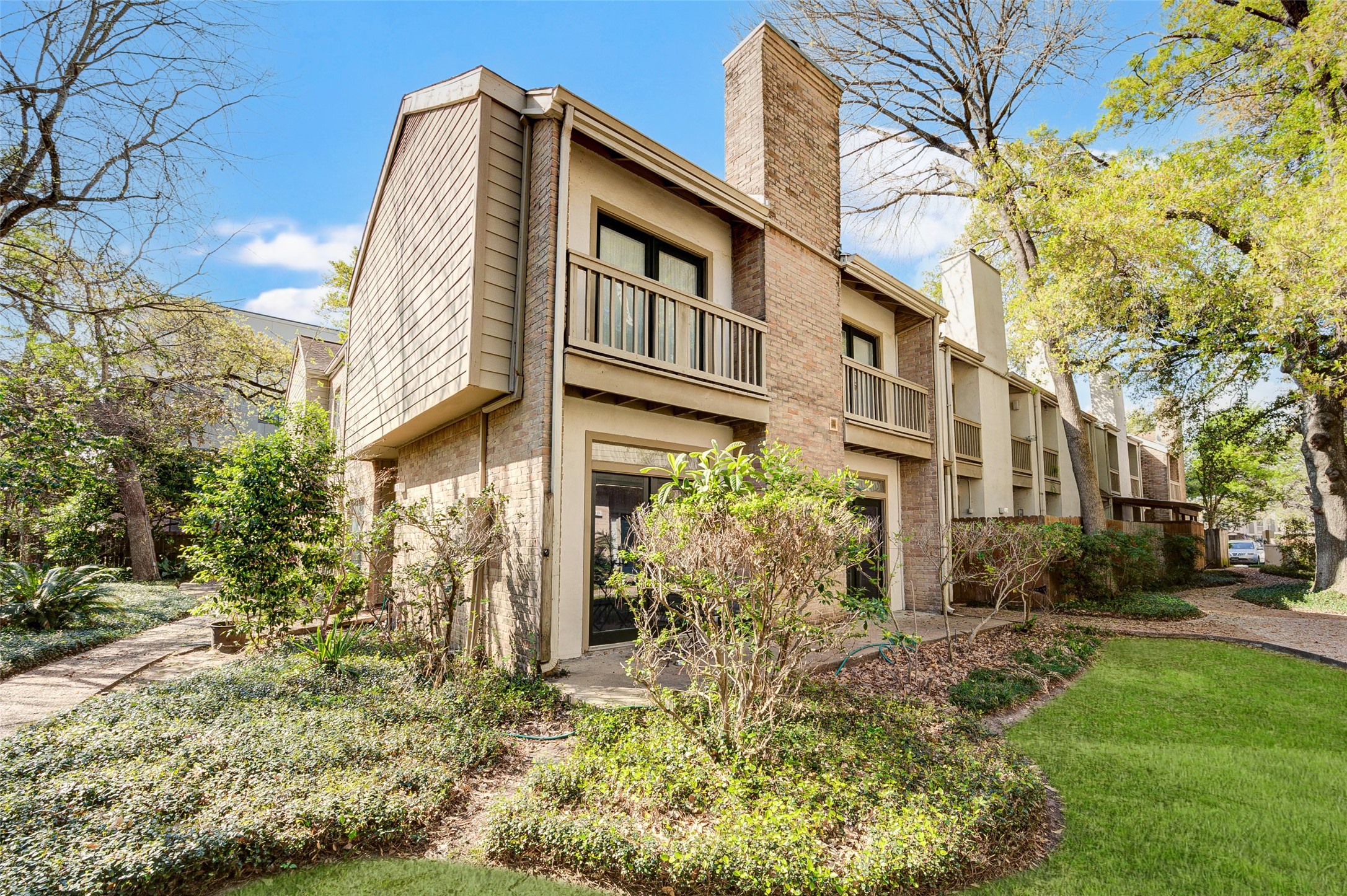 a front view of a building with a garden